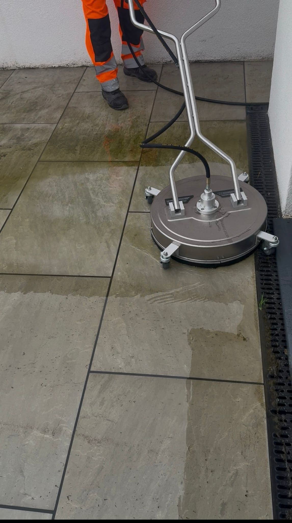 Professional patio cleaning in progress - before and after